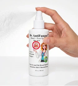 A hand holding a white bottle of Dr. AntiFungal Hand & Foot Spray against a white background with a light spray mist visible.